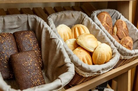 Premium Photo Assortment Of Fresh Bread In Baskets On The Shelves In