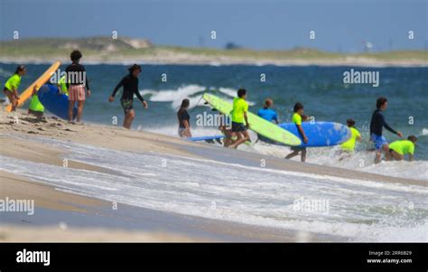 Gilgo Beach, New York, USA - 25 July 2023: Kids in neon green shirts ...