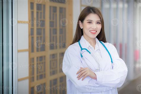 Professional Asian Woman Doctor Arms Crossed Wearing A White Robe And