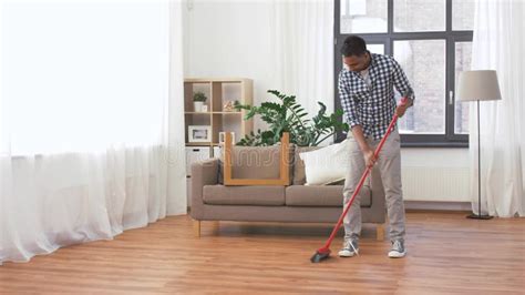 Man With Broom Cleaning And Having Fun At Home Stock Footage Video Of