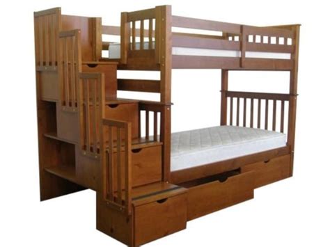 a wooden bunk bed with stairs and drawers on the bottom level, against ...