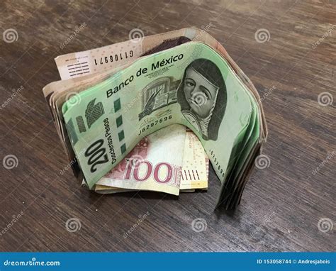 Many Mixed Mexican Peso Bills Spread Over a Wooden Desk Stock Photo ...