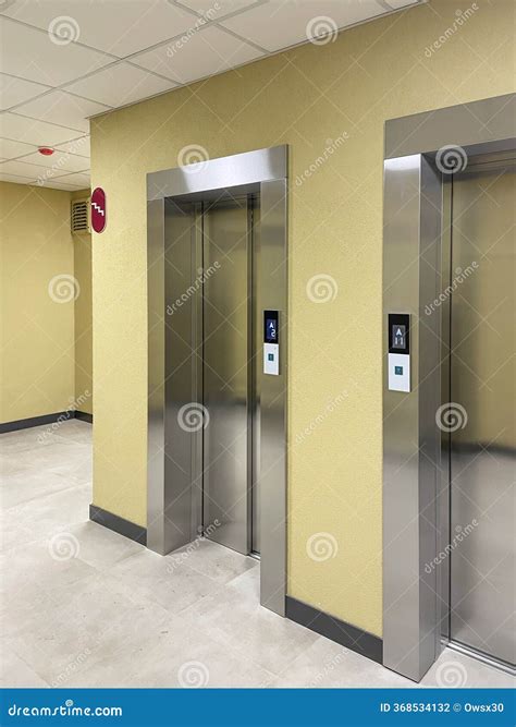 A Lobby With Elevators And Windows In A Building Stock Photo