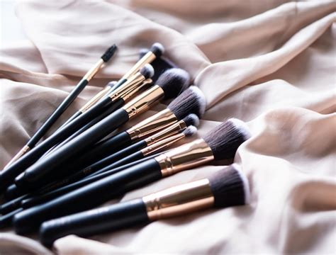 Premium Photo Set Of Luxurious Black Makeup Brushes On Beige Silk Fabric