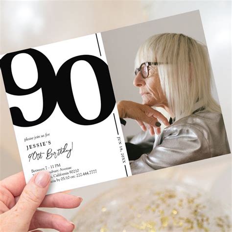 A Woman Holding Up A 90th Birthday Card