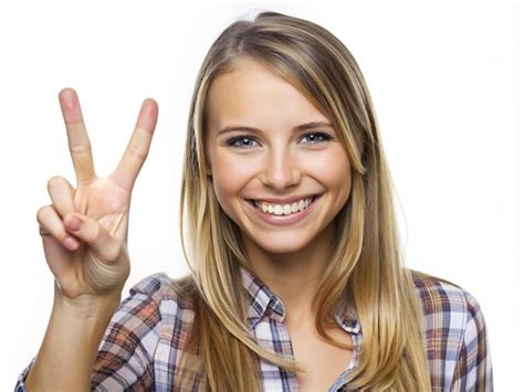 Premium Photo A Young Women Making A Peace Sign With Her Fingers