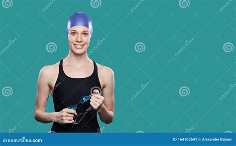 Woman Swimmer Smiling In Swimming Cap Holds Goggles In Hands Over