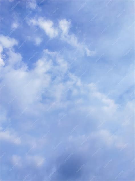 Premium Photo | A blue sky with clouds and a plane in the sky