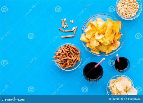 Snacks For Tv Watching Chips Nuts Soda Rusks On Blue Background Top