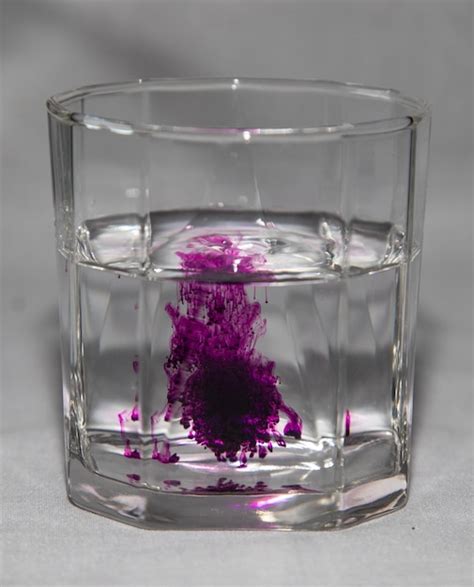 Premium Photo Potassium Permanganate In A Glass Of Water