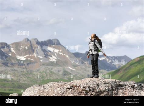 Full Body Portrait Of A Hiker Breathing Fresh Air On The Top Of A