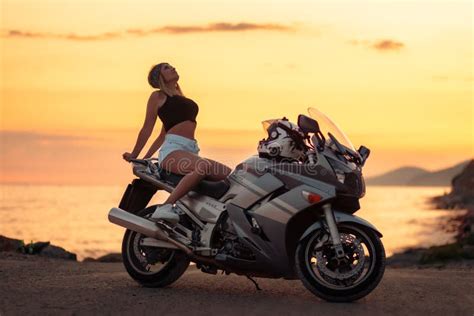 Freedom And Travel Caucasian Young Woman Poses Sitting On Motorcycle