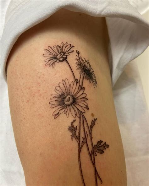 Daisy Flowers Tattoo Located On The Upper Arm