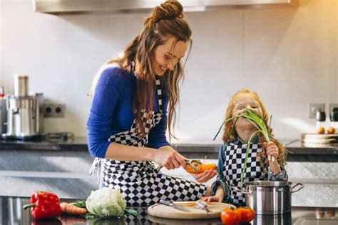 Mother And Daughter Cooking At Home Premium Photo