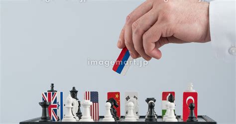 Politicians Hand Moves A Chess Piece With A Flag Conceptual Photo Of