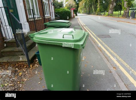 Green Garden Waste Bins On A Kerbside Waiting To Be Emptied Green Bins