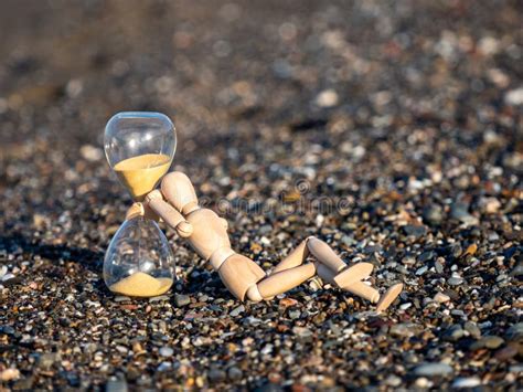 Wooden Stick Figure Next To Hourglass On The Beach At The Seashore Stock Image Image Of