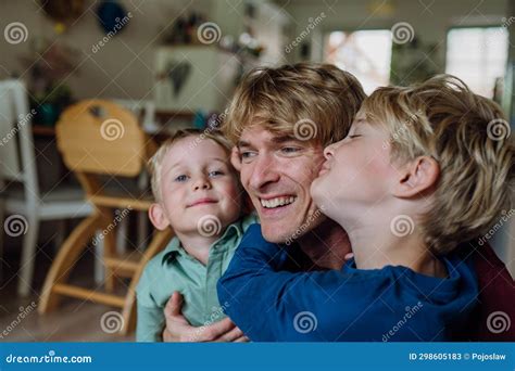 Two Sons Kissing Father S Cheeks Concept Of Father S Day And Fatherly