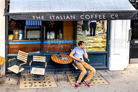 Man Sitting At Italian Coffee House Shop Caffe Nero On London Queen