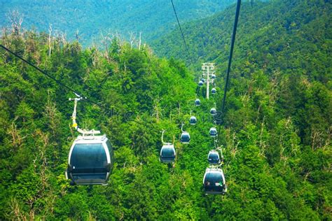 A Row Of Cabins On The Cable Car Above The Mountain Forest On The