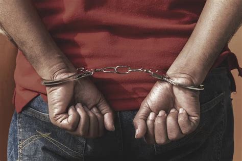 Arrested Man In Handcuffs — Stock Photo © Brianajackson 70908647