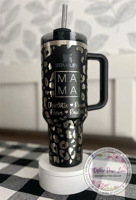 a black and gold leopard print travel mug with the name mama on it ...