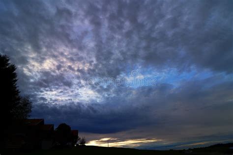 A Sunset with Dark Rain Clouds Stock Image - Image of evening, eerie ...