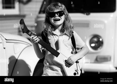 Excited Kid Boy With Musical Instruments Caucasian Little Boy Play