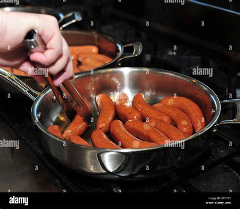 Sausages Frying In A Pan Stock Photo Alamy