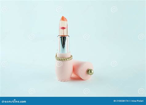 Opened Transparent Lipsticks With Flower Inside Isolated On Light Blue