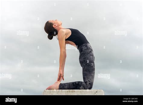 Woman Doing A Camel Pose Yoga Backbend Outside Stock Photo Alamy