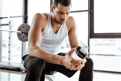 Sportsman Holding Sports Bottle With Protein Milkshake In Gym Stock