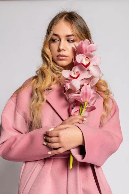 Premium Photo Seductive Blonde Woman In Pink Jacket Posing In Studio