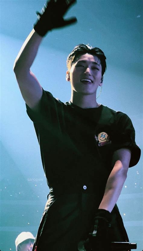 A Male In A Black Shirt Is Holding His Hands Up