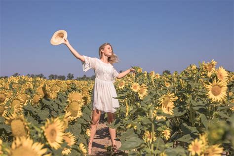 Beauty Sunlit Woman On Yellow Sunflower Field Freedom And Happiness