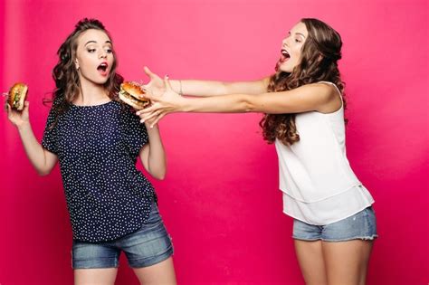 Premium Photo Hungry Girl Trying To Get Her Friends Burger