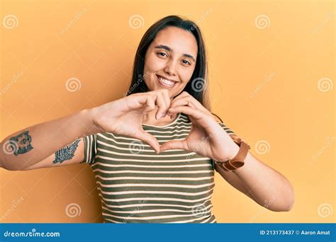 Young Hispanic Woman Wearing Casual Striped T Shirt Smiling In Love