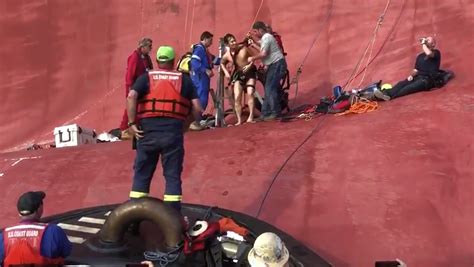 Rescued cargo ship crewmen pulled from heat, darkness, deep water