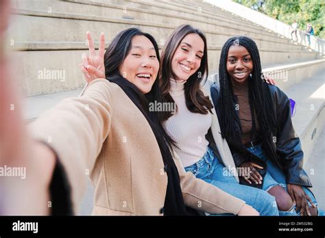 Happy Group Of Multiracial Young Women Taking A Selfie Portrait Smiling