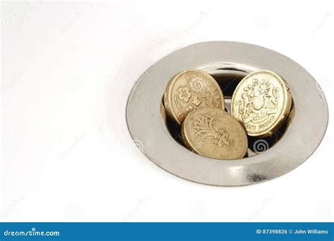 Three Pound Coins Money Down The Drain Stock Photo Image Of Banking