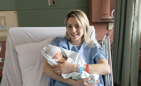 Mother With Her Newborn Baby At The Hospital A Day After A Natural