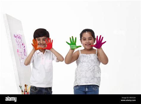 Portrait Of Two Children Showing Painted Hands Stock Photo Alamy