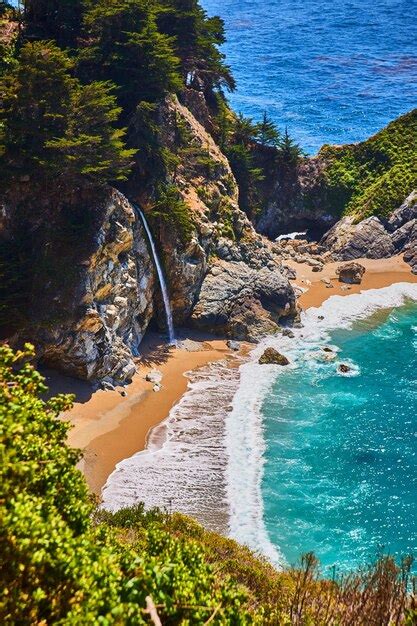 Premium Photo Hidden Waterfall On Sandy Beach Cove With Colorful