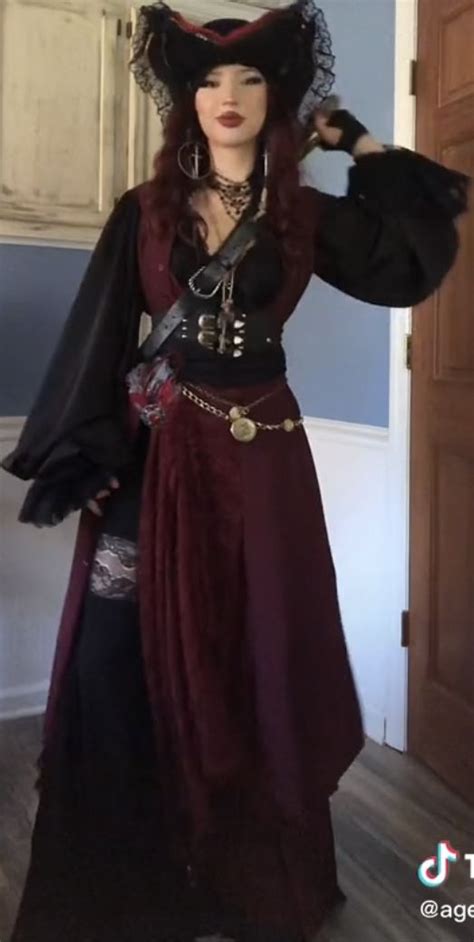 A Woman In A Pirate Costume Posing For The Camera