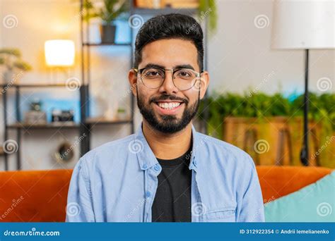 Portrait Of Happy Indian Man Looking At Camera And Smiling At Home