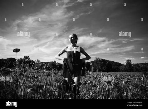 Girl In Flower Field Of Poppy Seed Stock Photo Alamy