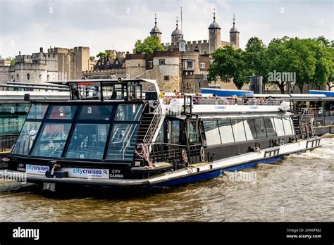 A City Cruises River Tour Boat With The Tower Of London In The ...