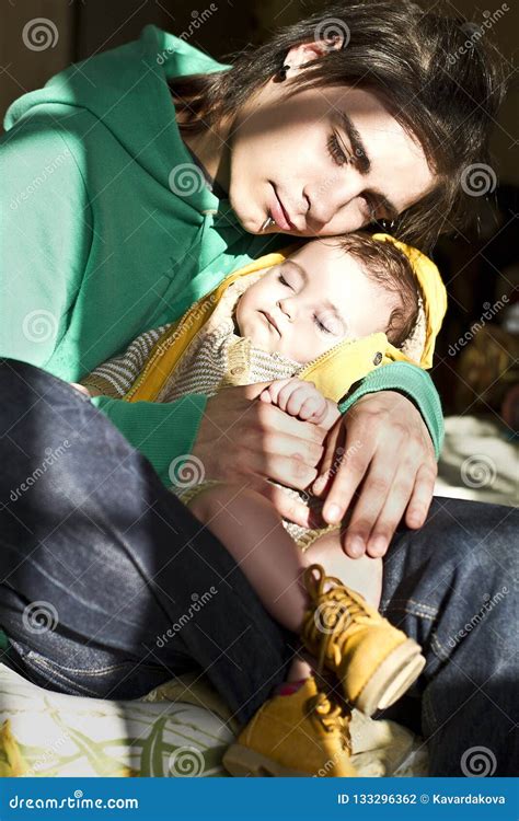 Man Holding A Sleeping Baby In His Arms Stock Photo Image Of Brothers