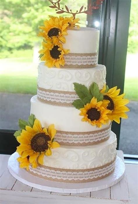 A Wedding Cake With Sunflowers On Top