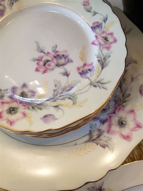 A Stack Of Plates With Flowers Painted On Them